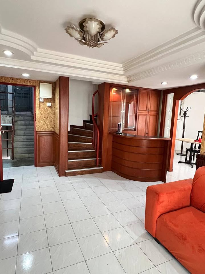 Living area with internal staircase and timber cabinets